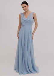 Model wearing a dusty blue bridesmaid dress in chiffon with cowl neckline and flowing chiffon skirt by TH&TH Bridesmaids.
