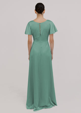 Model wears a sage green satin bridesmaid dress, flutter sleeves and keyhole back opening by TH&TH Bridesmaids. 
