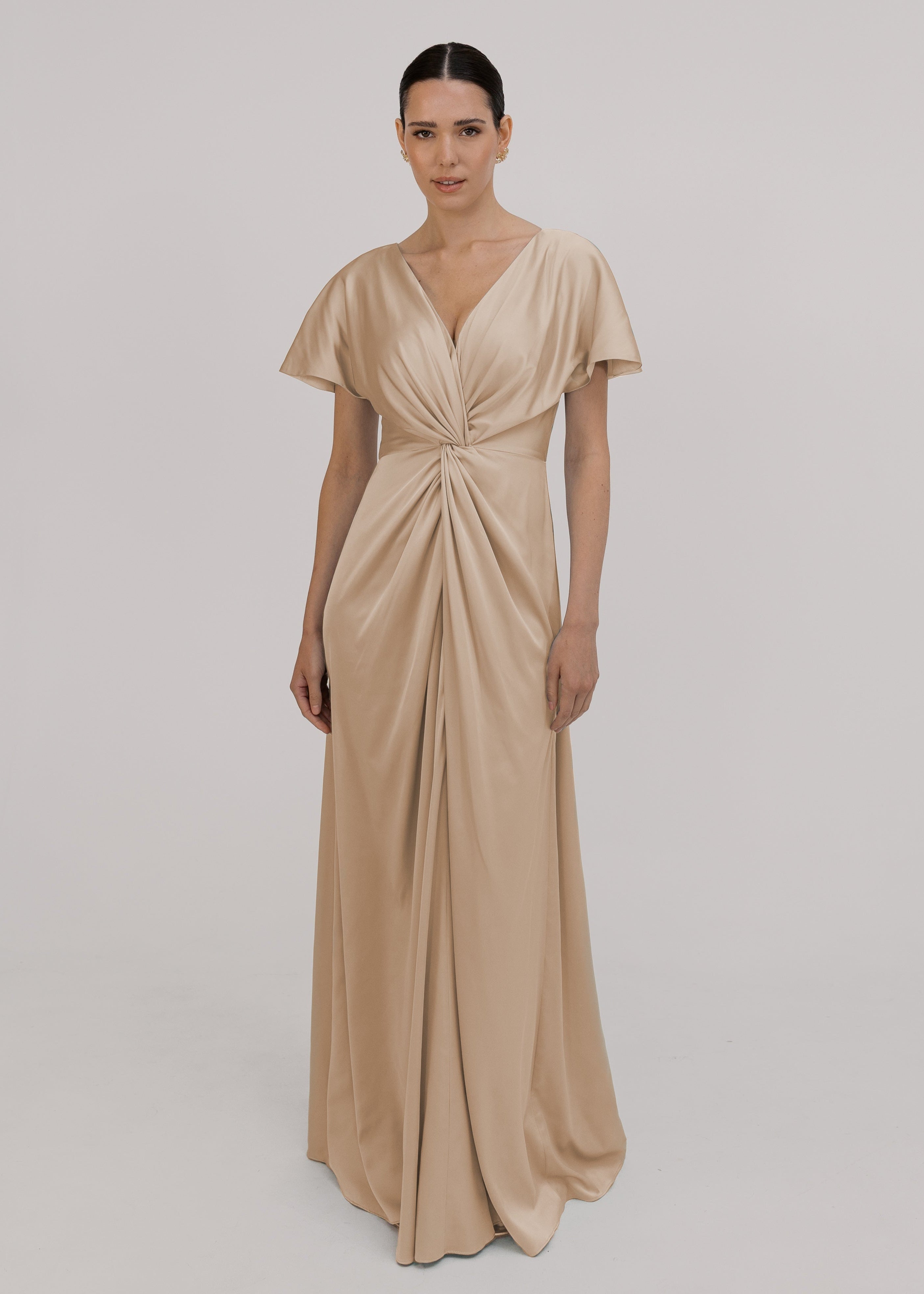 A champagne satin bridesmaid dress with v twist front neckline, flutter sleeves on a white background by TH&TH Bridesmaids. 

