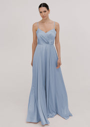 Model wearing a floor length dusty blue bridesmaid dress with V back and spaghetti straps by TH&TH Bridesmaids.