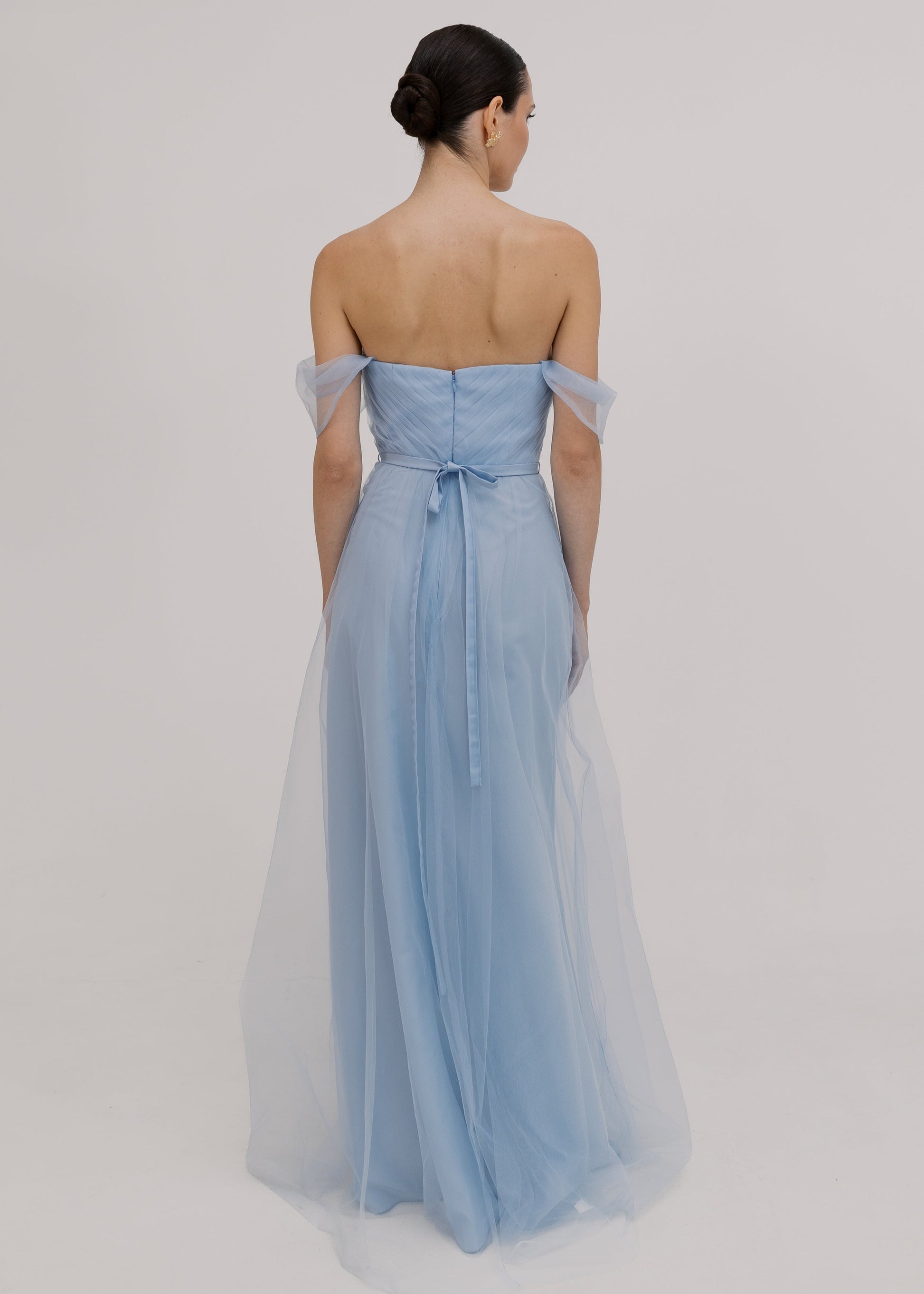 A dusty blue tulle bridesmaid dress with bardot sleeves by TH&TH Bridesmaids.
