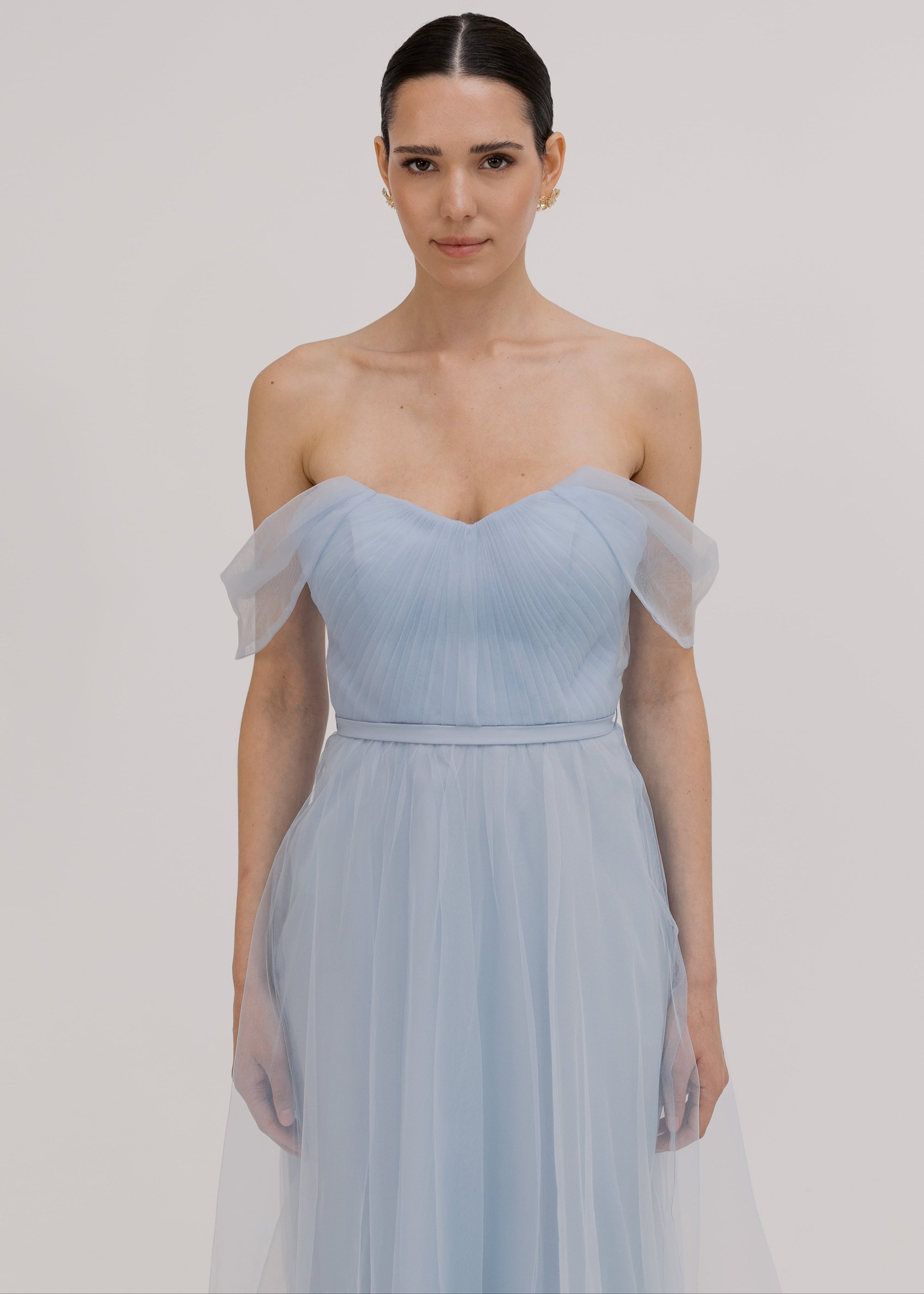 A dusty blue tulle bridesmaid dress with bardot sleeves by TH&TH Bridesmaids.
