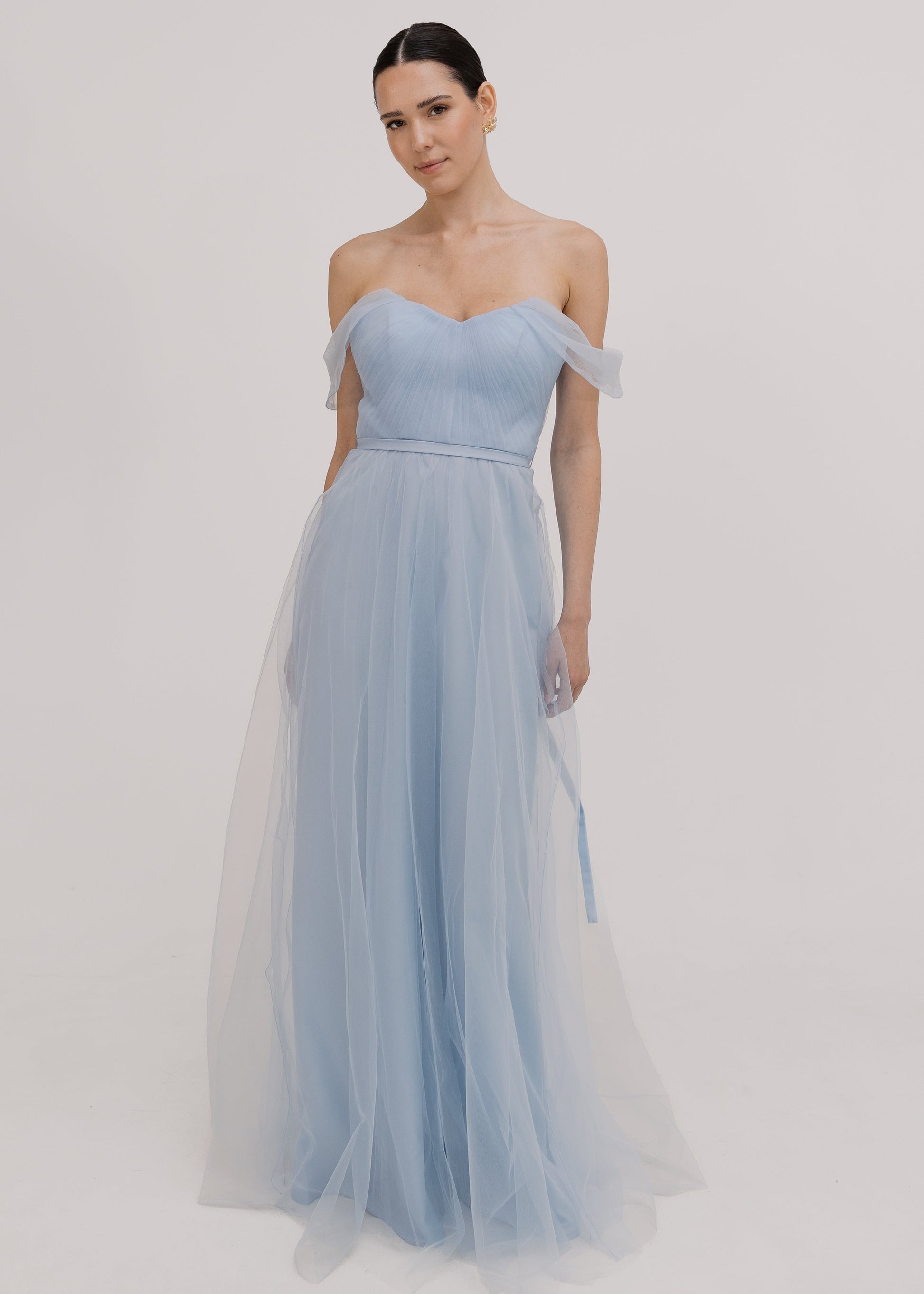 A dusty blue tulle bridesmaid dress with bardot sleeves by TH&TH Bridesmaids.
