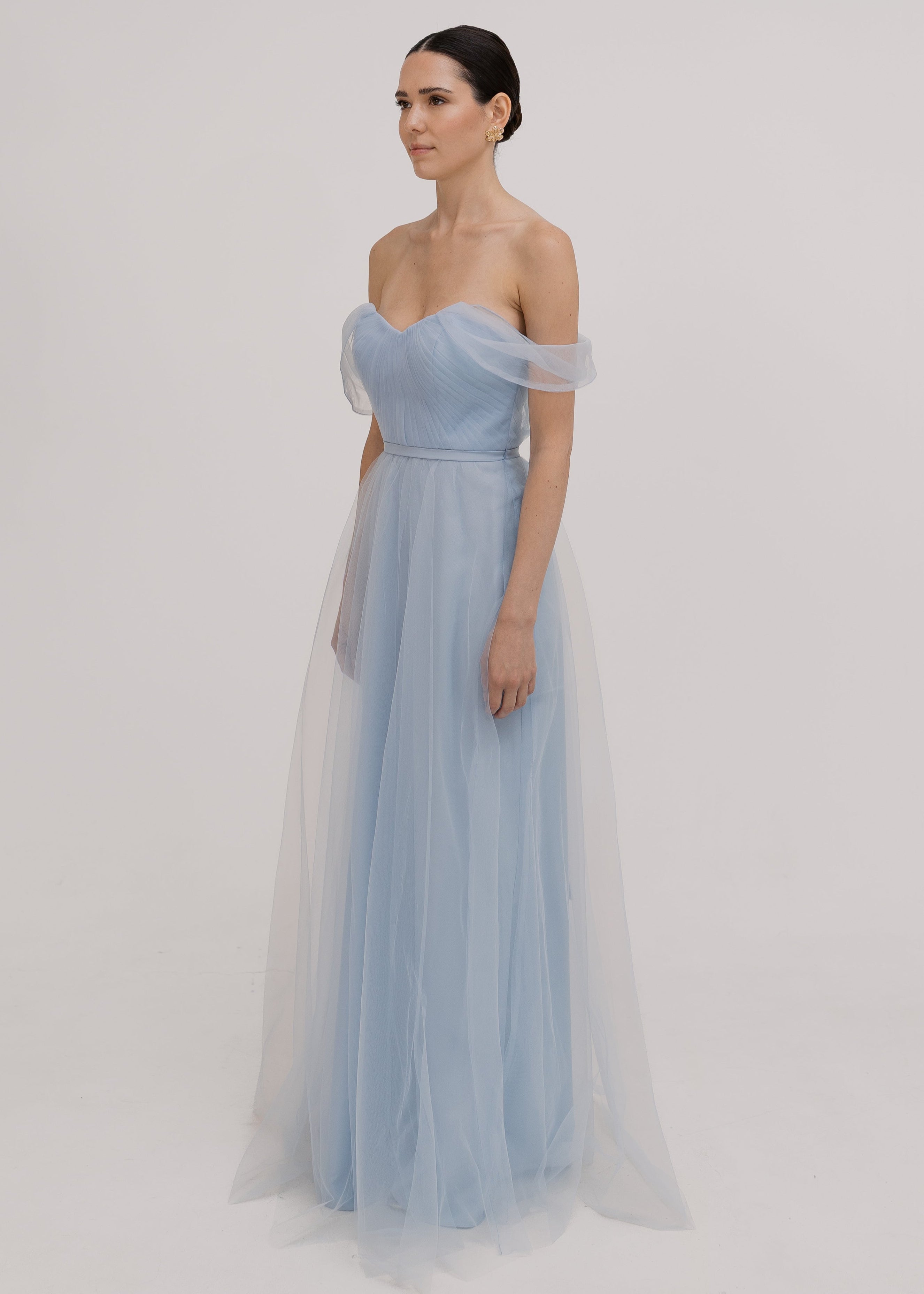 A dusty blue tulle bridesmaid dress with bardot sleeves by TH&TH Bridesmaids.
