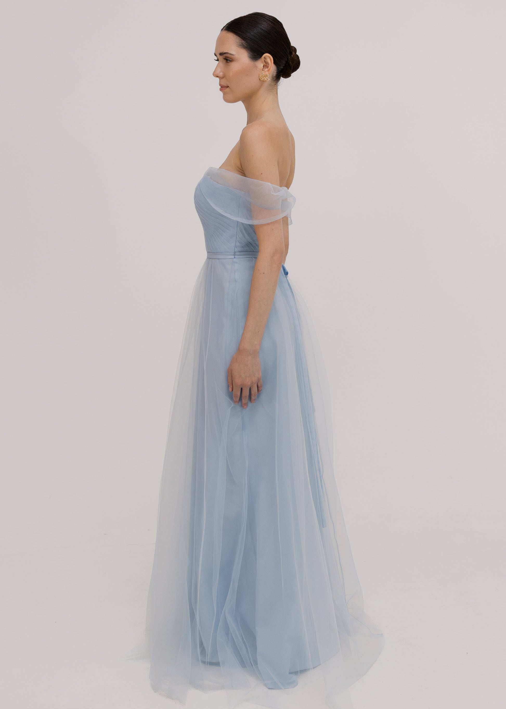A dusty blue tulle bridesmaid dress with bardot sleeves by TH&TH Bridesmaids.

