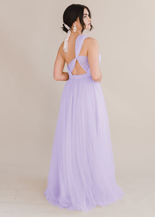 A woman wearing a lilac bridesmaid dress with one shoulder strap back view on a white background by TH&TH Bridesmaids. 
