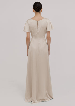 Woman wearing an oyster bridesmaid dress with short sleeves by TH&TH.