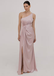 Woman wearing a one-shoulder pink bridesmaid dress with a slit by TH&TH.