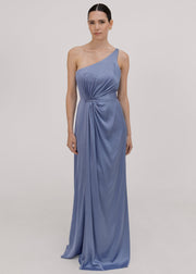 Woman wearing a long blue bridesmaid dress with one shoulder, in french blue satin.