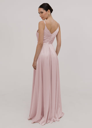 Woman wearing a smoked blush pink satin bridesmaid dress by TH&TH.