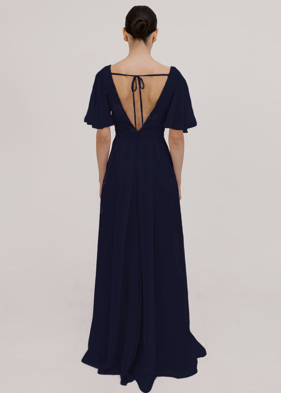 Woman wearing a long navy bridesmaid dress with angel sleeves and V neck in chiffon.