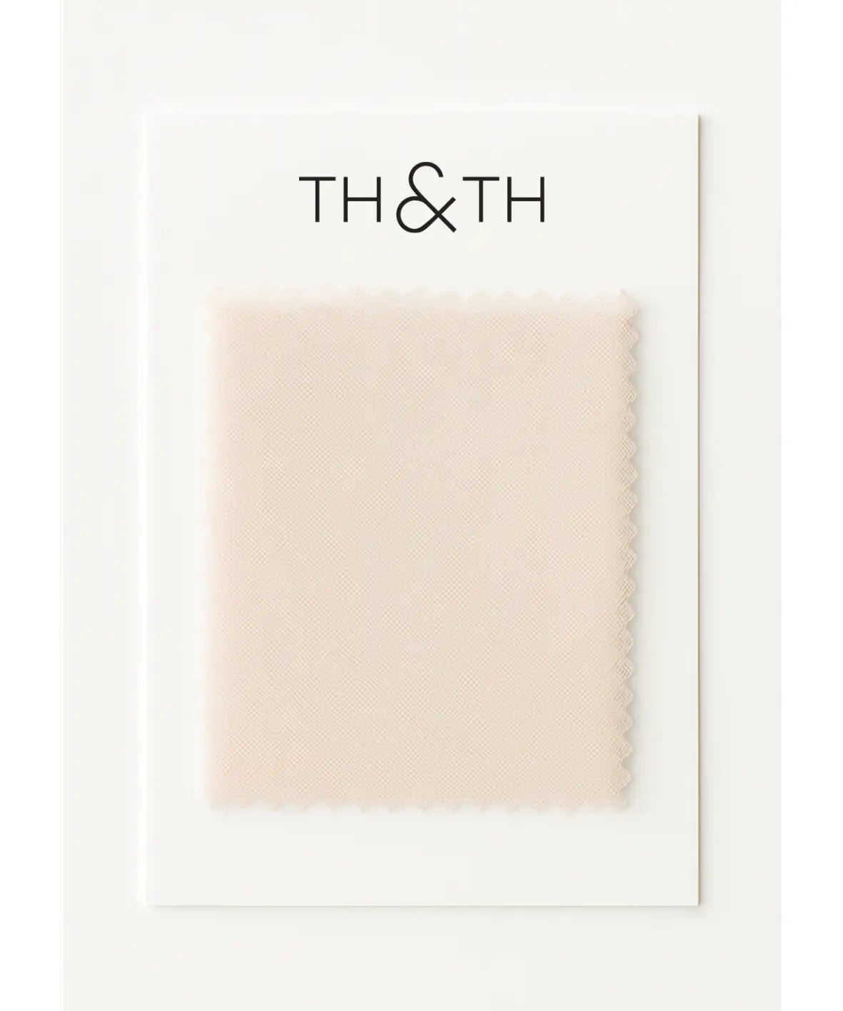 A pale beige Tulle Swatch by TH & TH with zigzag edges is attached to a white card labeled "TH & TH." The swatch features a subtle, smooth texture ideal for creating an ethereal bridesmaid look.