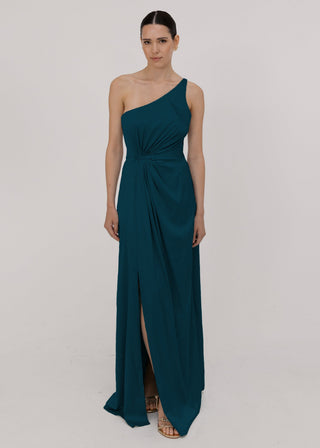 Woman wearing a long emerald dawn green bridesmaid dress with one shoulder and cinched waist in satin